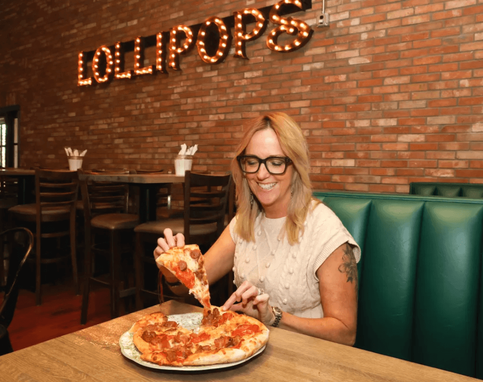 Guest enjoying a pizza inside Lollipops